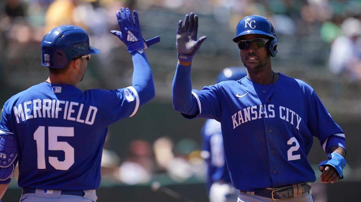 Kansas City Royals’ Michael A. Taylor (2) is congratulated by Whit Merrifield (15) after scoring against the Oakland Athletics during the seventh inning of a baseball game in Oakland, Calif., Saturday, June 18, 2022. (AP Photo/Jeff Chiu)