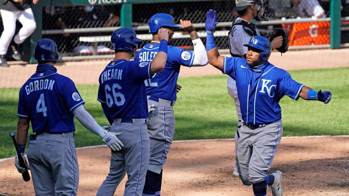 Kansas City Royals’ Maikel Franco, right, celebrates with teammates after hitting a three-run home run during the seventh inning against the Chicago White Sox in Chicago, Saturday, Aug. 29, 2020. (AP Photo/Nam Y. Huh)