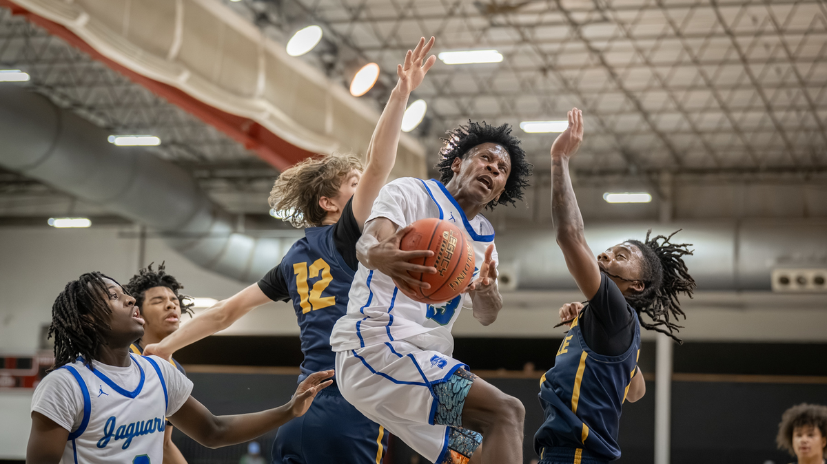 Chris Ellis leaps through Battle defenders in Blue Springs South’s 55-53 win in the Holley Division title game in the William Jewell Classic boys high school basketball tournament on Tuesday, Dec. 30, 2025 in Liberty, Missouri.