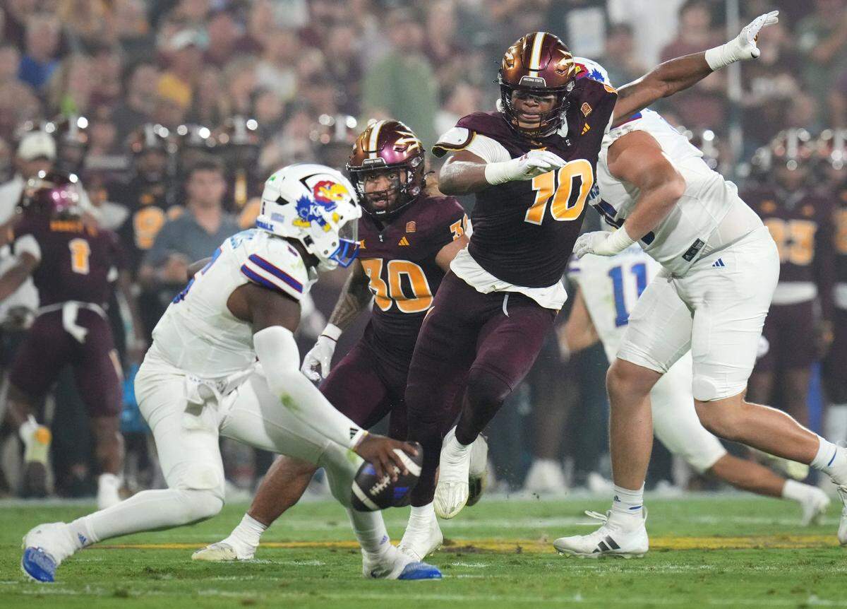 Arizona State defensive lineman Clayton Smith (10) closes in for a sack on Kansas quarterback Jalon Daniels (6) at Mountain America Stadium on Oct. 5, 2024.
