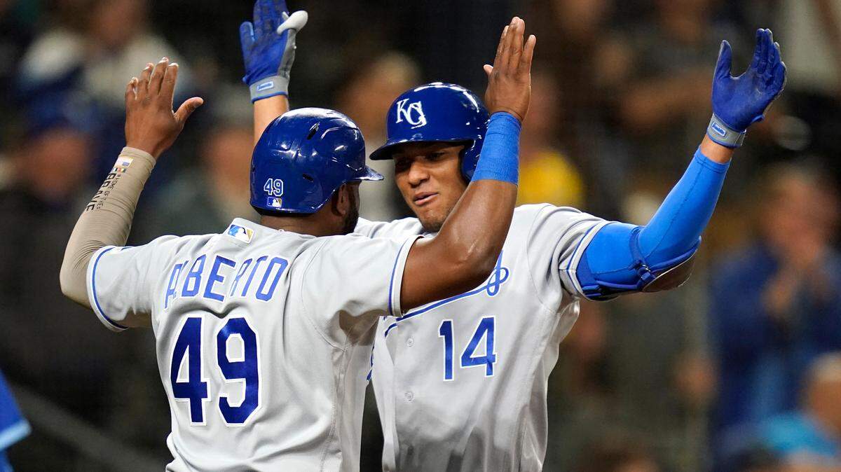 Kansas City Royals’ Edward Olivares (14) celebrates his two-run home run against the Seattle Mariners with Hanser Alberto in the 12th inning of a baseball game Friday, Aug. 27, 2021, in Seattle. (AP Photo/Elaine Thompson)