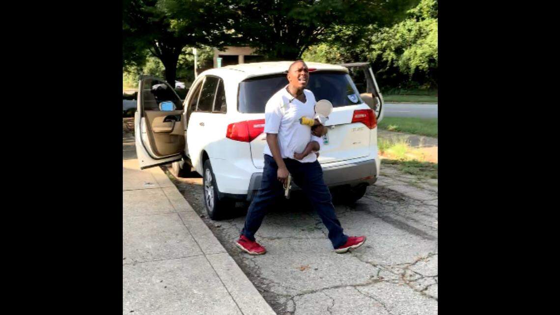 A man holding a baby and gun during a road rage shooting in Cincinnati, Ohio, fired shots at three women, injuring one, police say. Photo from Cincinnati Police Department.