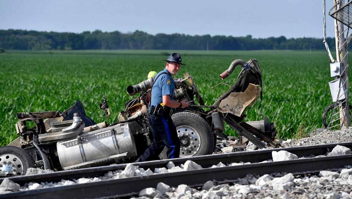 Several cars of an Amtrak train traveling from Los Angeles to Chicago derailed Monday afternoon after it struck a dump truck at a crossing in northern Missouri, Amtrak announced. More than 200 people were on board the train at the time of the crash, which was first reported about 12:43 p.m. near Mendon, Missouri, according to the Missouri State Highway Patrol. Three people were killed in the crash, the patrol said, including two people on the train and one person in the dump truck. A Highway Patrol officer looked over the wreckage of the truck.