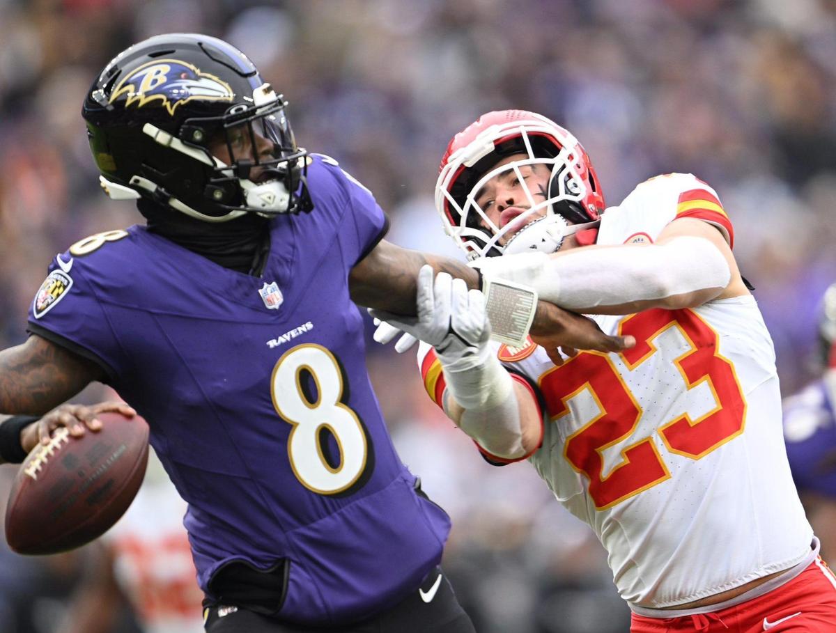Kansas City Chiefs linebacker Drue Tranquill (23) grabs Baltimore Ravens quarterback Lamar Jackson (8) while he attempts to throw a pass in the first quarter Sunday, Jan. 28, 2024, during the AFC Championship Game in Baltimore.
