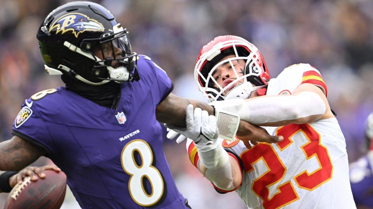 Kansas City Chiefs linebacker Drue Tranquill (23) grabs Baltimore Ravens quarterback Lamar Jackson (8) while he attempts to throw a pass in the first quarter Sunday, Jan. 28, 2024, during the AFC Championship Game in Baltimore.
