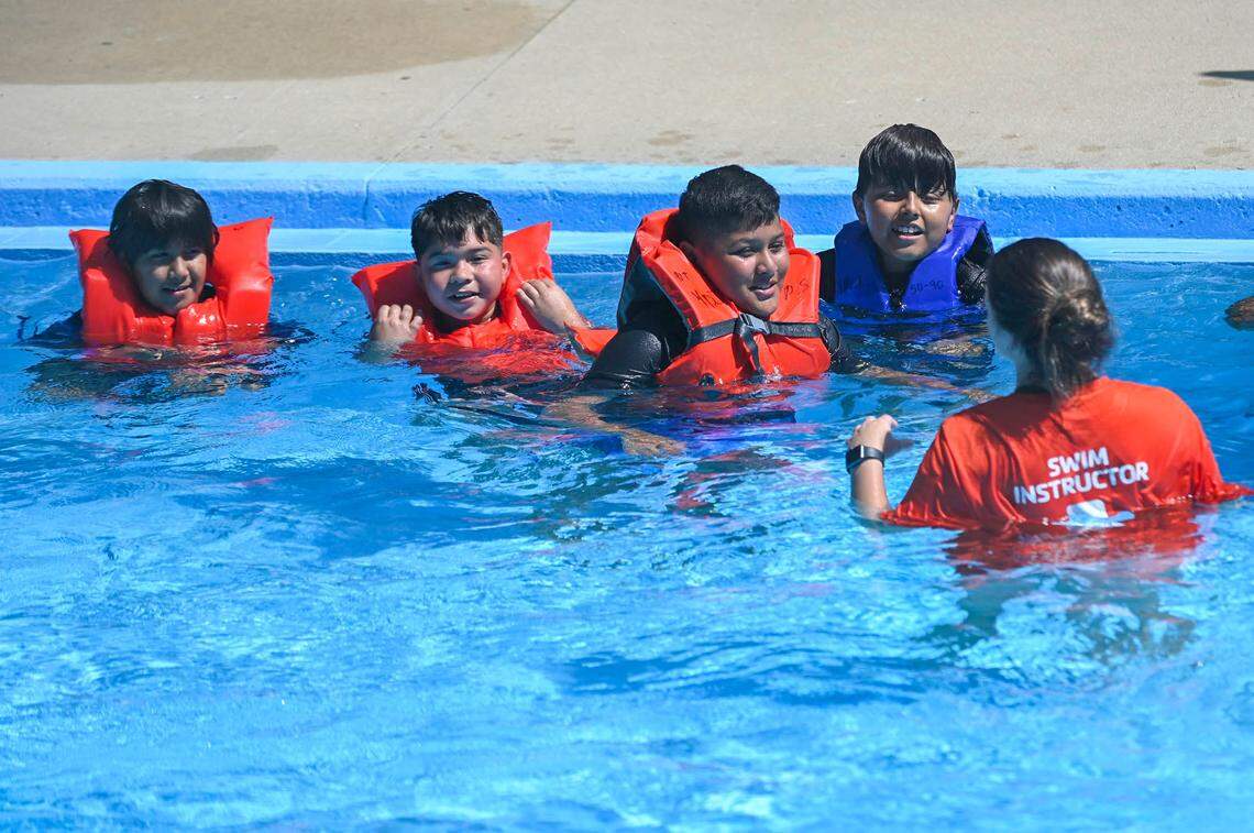 Swim instuctor Mackenzie worked with a group of students during a swim lesson on Wednesday, July 13, 2022, at the Parkwood Pool in Kansas City, Kansas. With a sponsorship from GEHA, the pool has teamed up with the YMCA of Greater Kansas City, to provide swim lessons to 200 local children at the recently re-opened pool. During an employee donation drive GEHA employees donated googles, sunscreen and swim suits. The health benefits company also provided towels and swim caps for the children in the lessons.