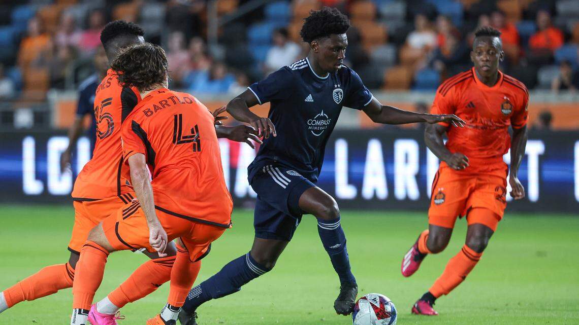 Sporting Kansas City forward Stephen Afrifa attempts to control the ball against a wave of Dynamo players during Wesnesday night’s Lamar Hunt U.S. Open Cup match in Houston.