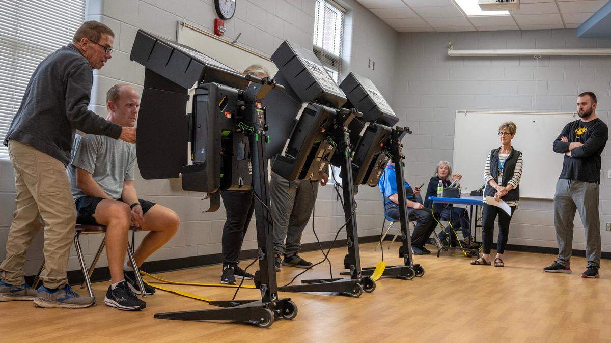 Voters lined up to cast their ballots Tuesday in Overland Park. Results showed several moderate candidates winning out over conservative challengers in Johnson County school board races.