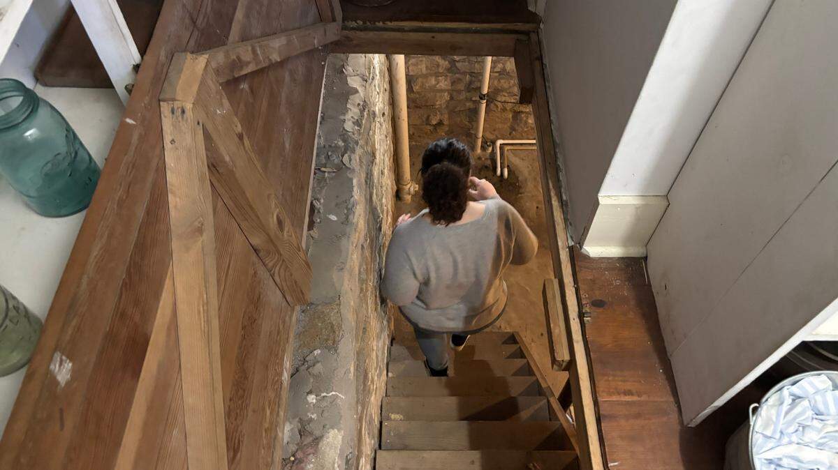 Sarah Bader-King, executive director of the Wornall/Majors House Museums, descends into the cellar of the Majors House, located at 82nd and State Line Road. Up to 22 enslaved people resided at the house, which was built in 1856.