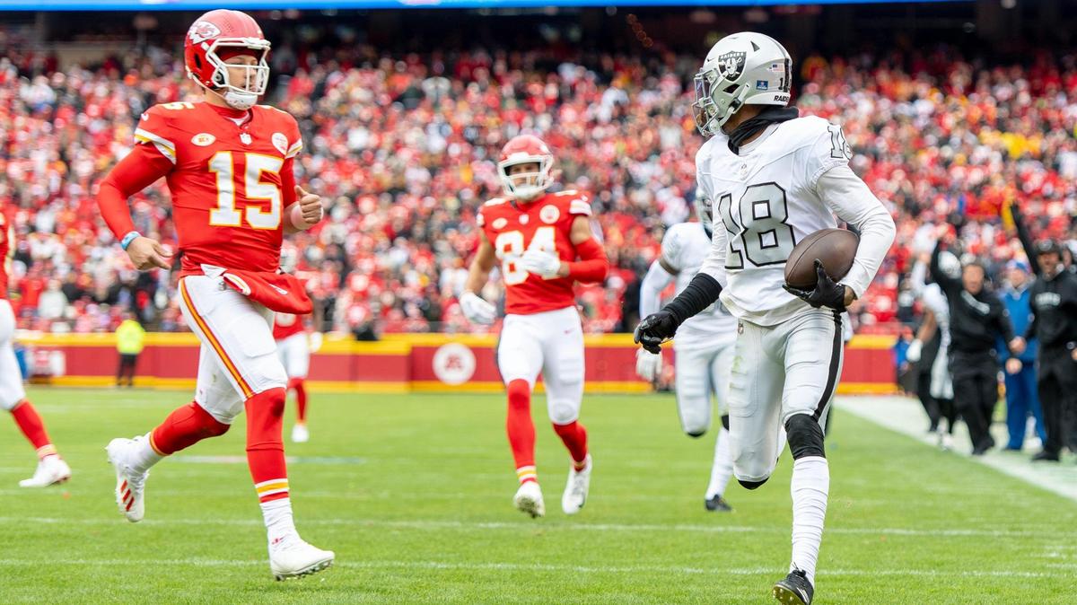 Las Vegas Raiders cornerback Jack Jones (18) stares down Kansas City Chiefs quarterback Patrick Mahomes (15) as he returns an interception for a touchdown during an NFL football game on Monday, Dec. 25, 2023, at Arrowhead Stadium at GEHA Field in Kansas City.