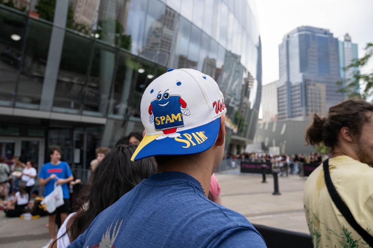A fan of Childish Gambino wears a hat that Gambino was wearing on his most recent album cover, before the Gambino concert in Kansas City, August 12, 2024. Fans were dressed in his likeness throughout the crowd.