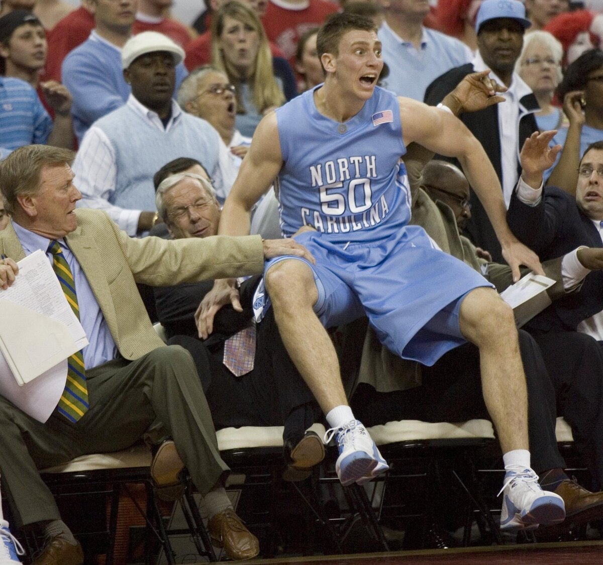 UNC’s Tyler Hansbrough (50) takes on seat on the bench beside coach Roy Williams after chasing a loose ball out of bounds during the first half of play against N.C. State on Wednesday February 20, 2008 in the Smith Center.