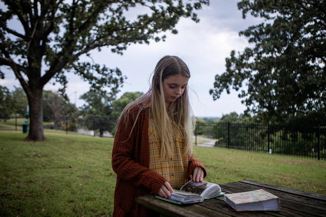 Desi Henderson looked through old family photos outside her apartment in Tulsa, Oklahoma.