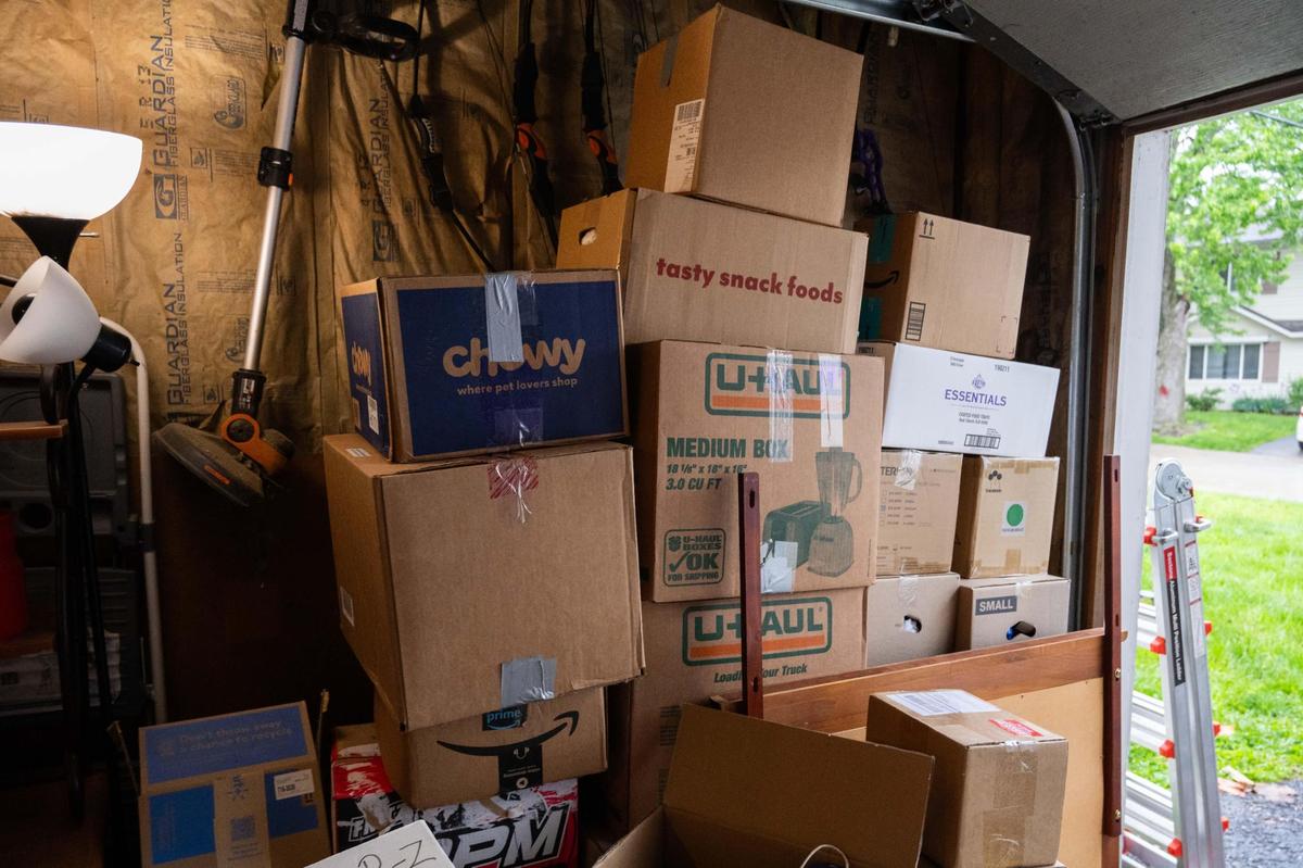 Boxes pile up in the garage of Leticia Rodriguez at Aspen Place Apartments in Gardner on Wednesday, May 7, 2025. Residents were forced to move in 48 hours after the city condemned the entire apartment complex due to several dangerous factors.