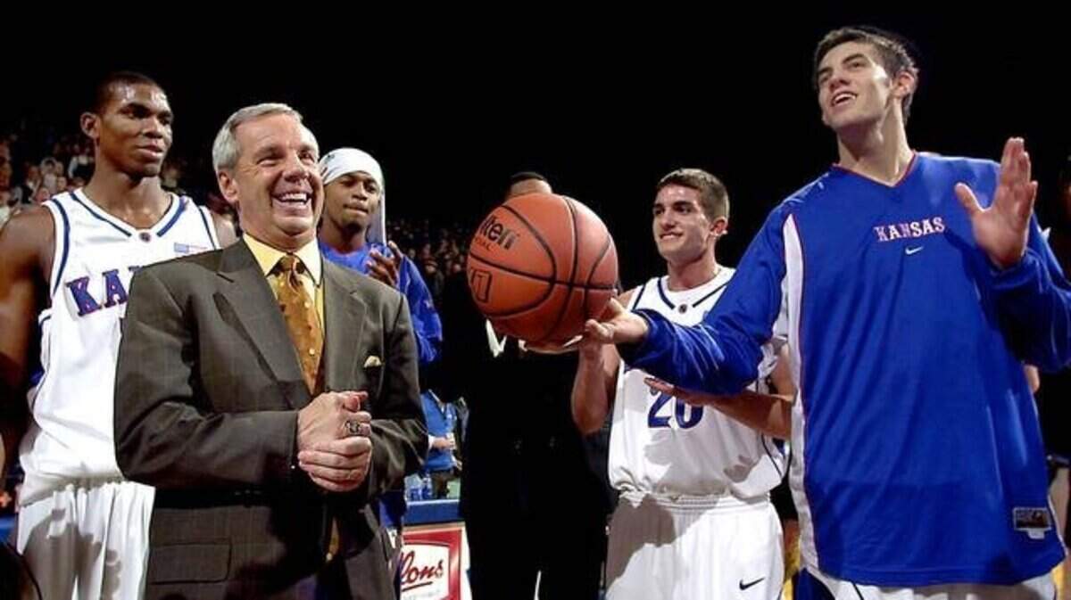 Then-Kansas men’s basketball coach Roy Williams got the game ball after posting his 400th win in 2003 at Allen Fieldhouse. Senior Nick Collison (right) presented him the game ball. At left is Bryant Nash.