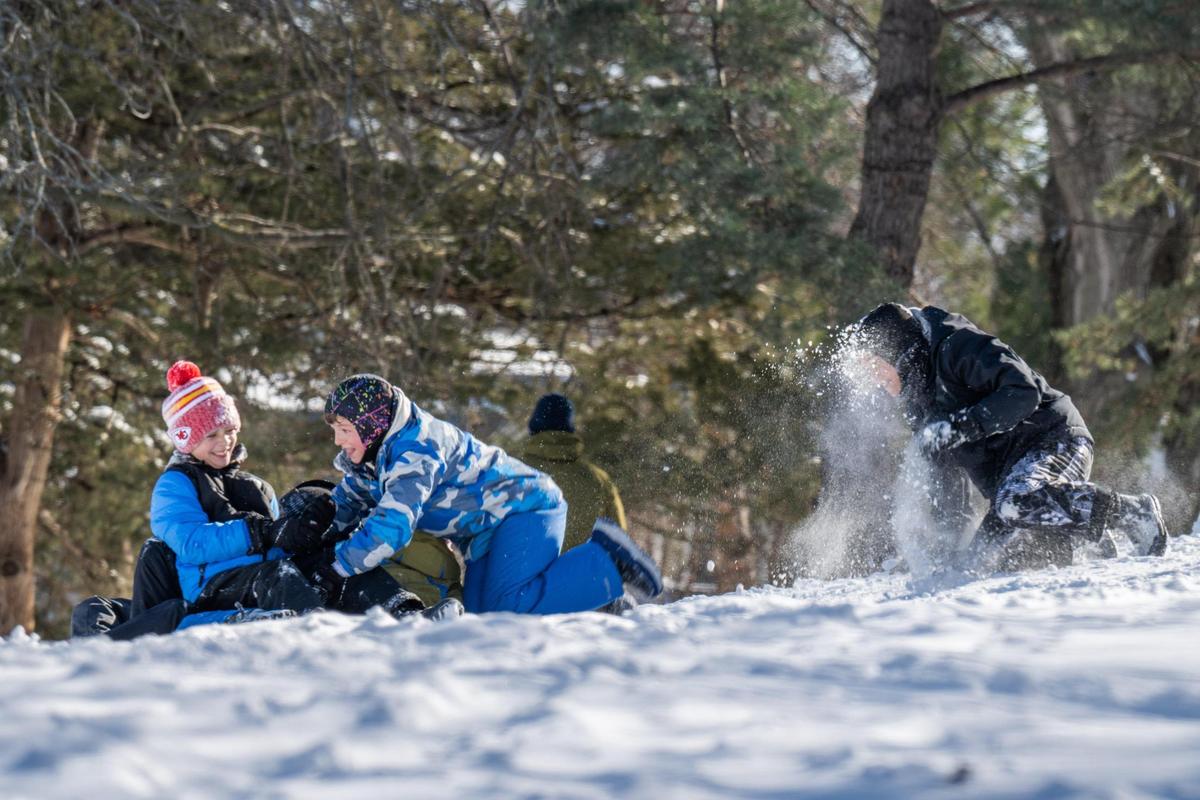 A group of kids in the Westwood neighborhood in Kansas City have some fun in the snow on Monday, Jan. 6, 2025.