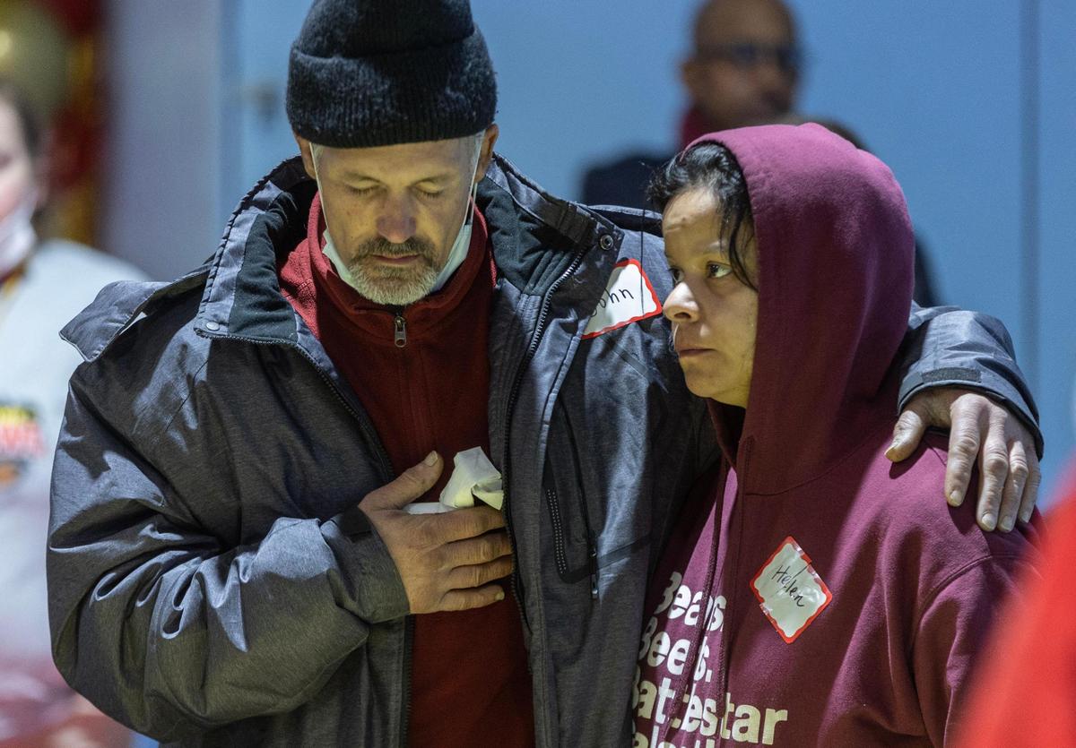 John and Helen Williamson stood for the national anthem during a Super Bowl watch party for Kansas City’s homeless Sunday at the Cathedral of the Immaculate Conception.