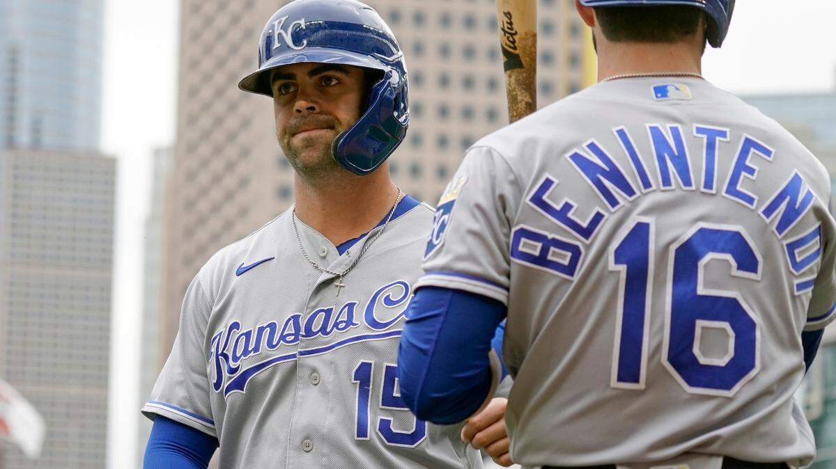 Kansas City Royals’ Whit Merrifield (15) is greeted by teammate Andrew Benintendi after scoring on a sacrifice fly by Salvador Perez off Minnesota Twins pitcher Baile Ober in the first inning of a baseball game, Sunday, Sept. 12, 2021, in Minneapolis. (AP Photo/Jim Mone)