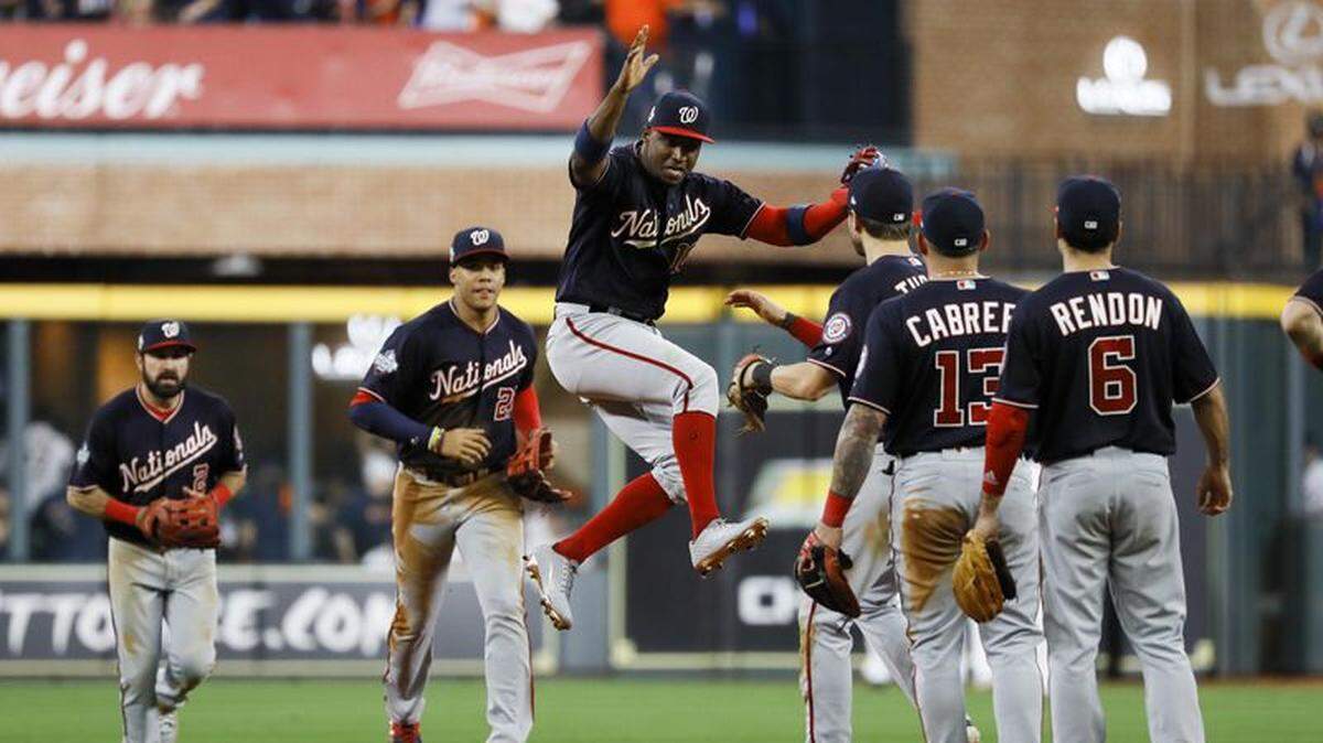 The Washington Nationals celebrate after their win against the Houston Astros in Game 1 of the World Series Tuesday in Houston.