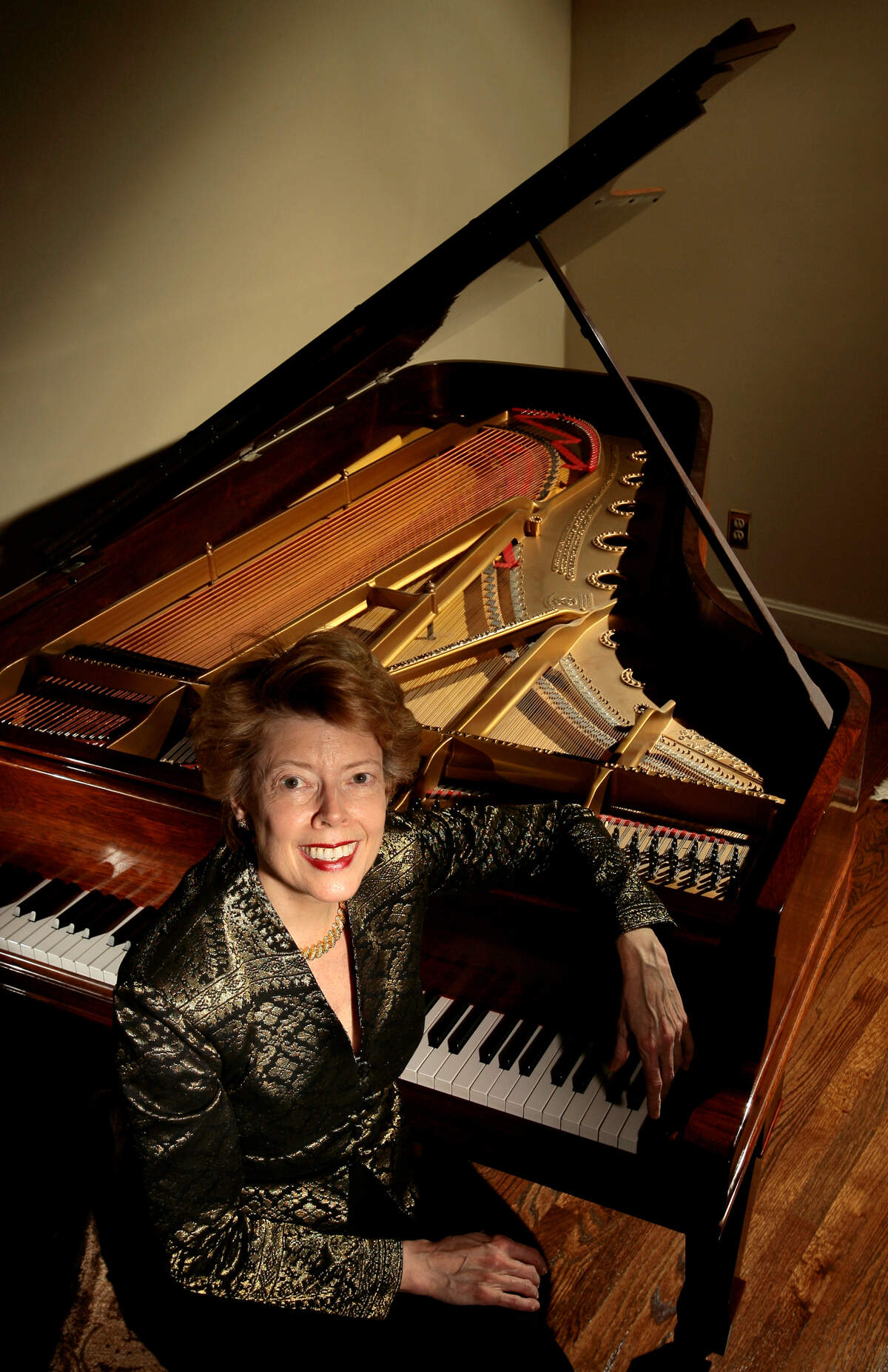 Cynthia Siebert, founder of Friends of Chamber Music, sits with her 1881 Steinway grand piano in her Kansas City home in 2009.