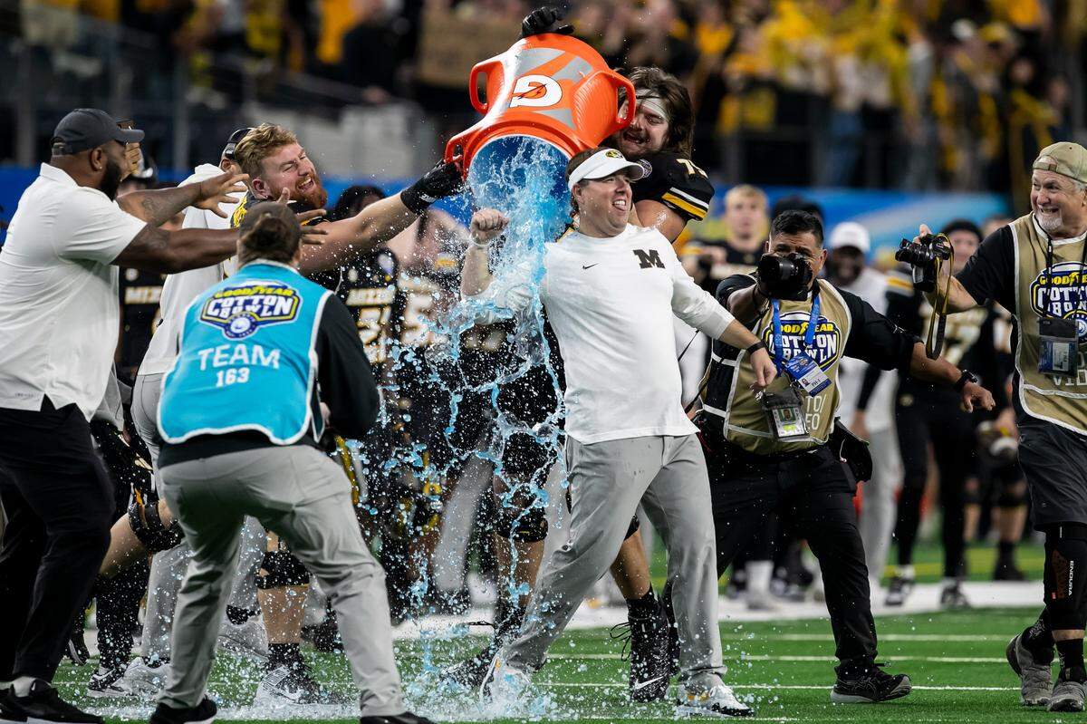 Missouri Tigers football coach Eliah Drinkwitz gets a Gatorade bath after his team’s 14-3 victory over Ohio State in the 88th annual Cotton Bowl on Friday at AT&T Stadium in Arlington, Texas.