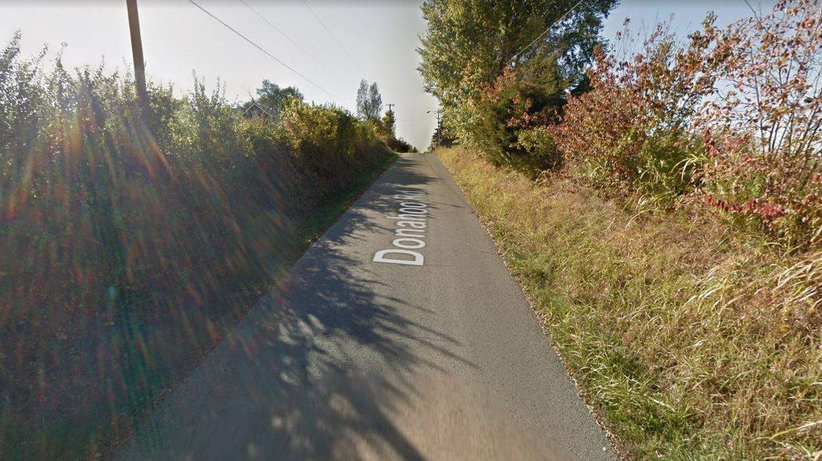 Kansas City, Kansas, police are investigating after a person was found dead inside a vehicle that was down an embankment and on fire late Wednesday in the 6700 block of Donahoo Road. A Google Maps street view image from Oct. 2011 shows the general area.