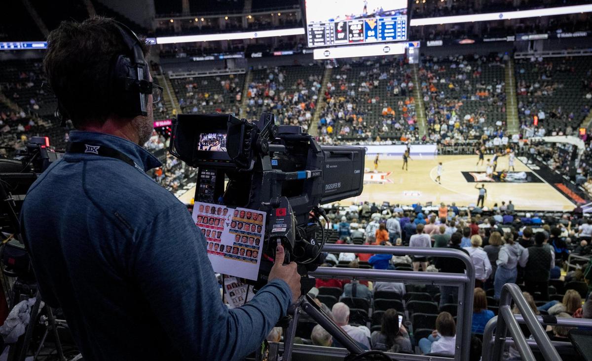 An ESPN camera operator controls his setup while televising a game during the Big 12 basketball tournament Tuesday at T-Mobile Center.