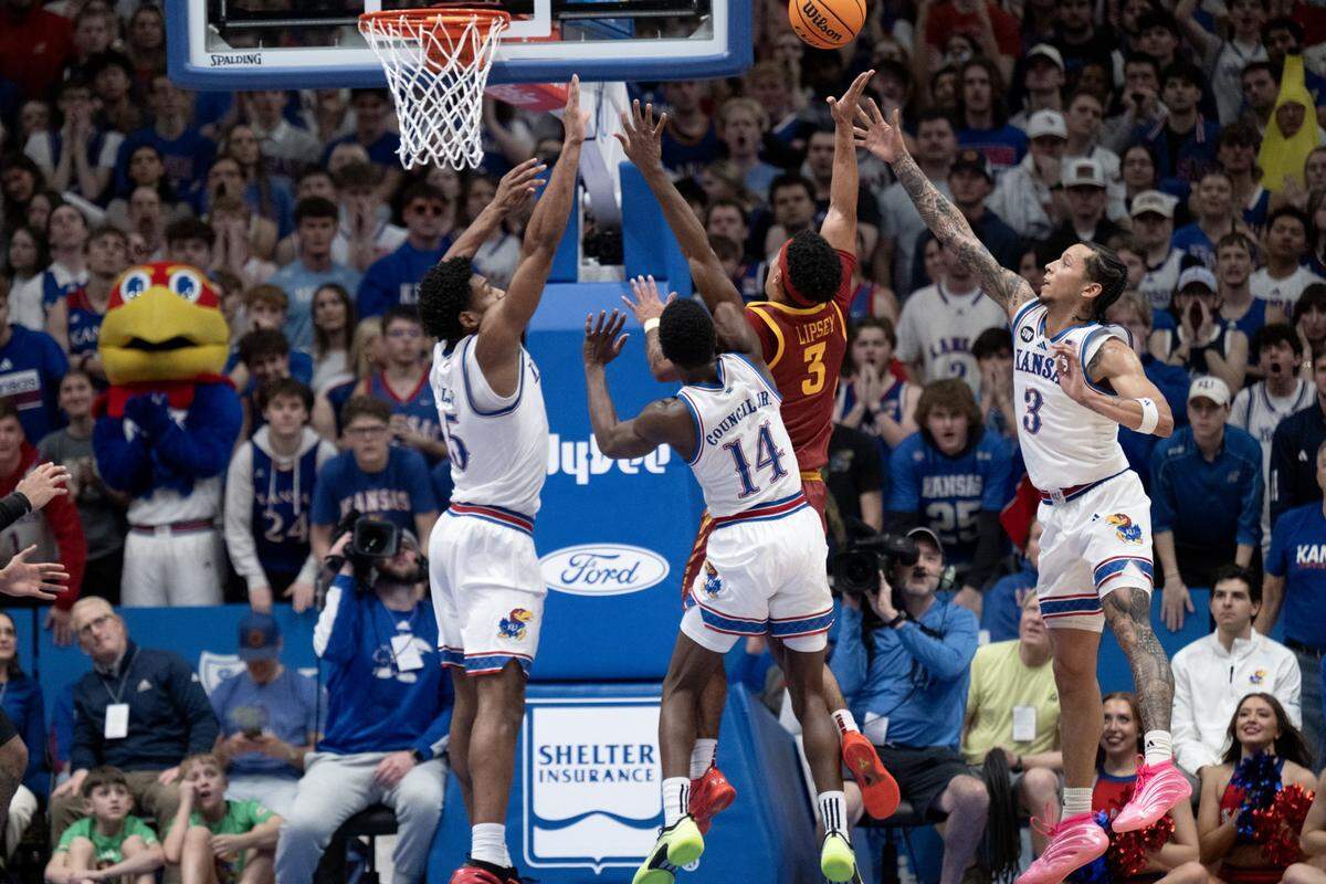 Kansas Jayhawks forward Bryson Tiller, guard Melvin Council Jr. (14) and guard Tre White (3) defend as Iowa State Cyclones guard Tamin Lipsey (3) goes up for a shot in the second half on Tuesday, Jan. 13, 2026, at Allen Fieldhouse in Lawrence, Kansas.