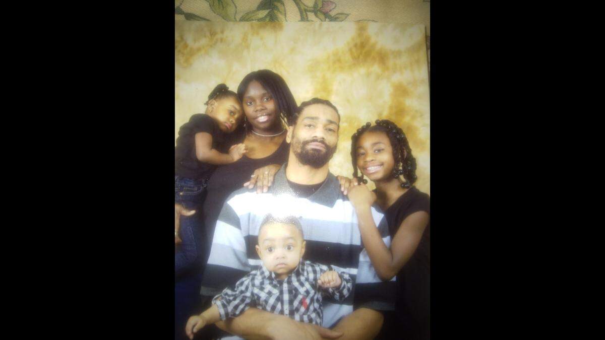 Nicholas Lewis and Adrian Booker with their children Nicholas Jr., Parys, and London.