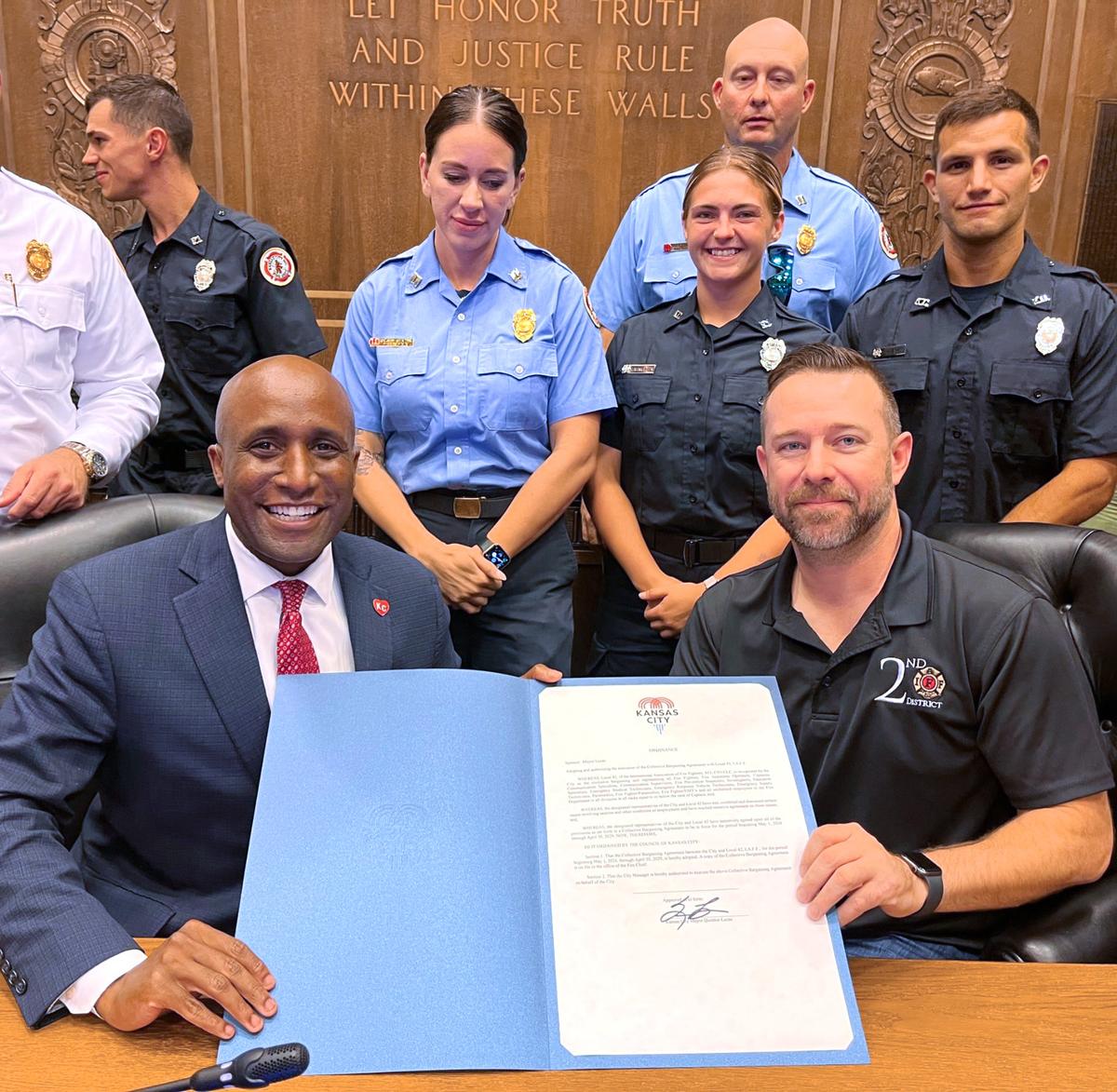 Kansas City Mayor Quinton Lucas celebrates the approval in August 2024 of a new five-year labor contract with members of Local 42 of the International Association of Fire Fighters.