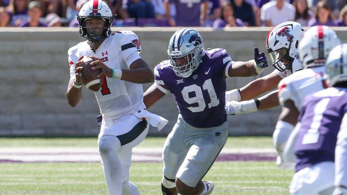 Texas Tech Red Raiders quarterback Donovan Smith (7) is chased by Kansas State Wildcats defensive end Felix Anudike-Uzomah (91) during the third quarter at Bill Snyder Family Football Stadium.
