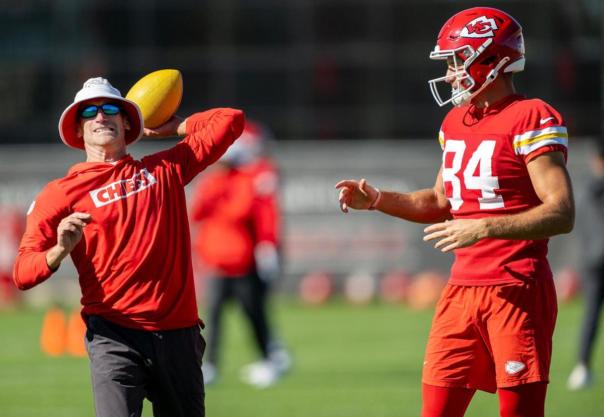 Joe Bleymaier, Chiefs pass game coordinator, throws a pass as Chiefs wide receiver Justin Watson looks on during the team’s practice on Friday, Nov. 11, 2024, in Kansas City.