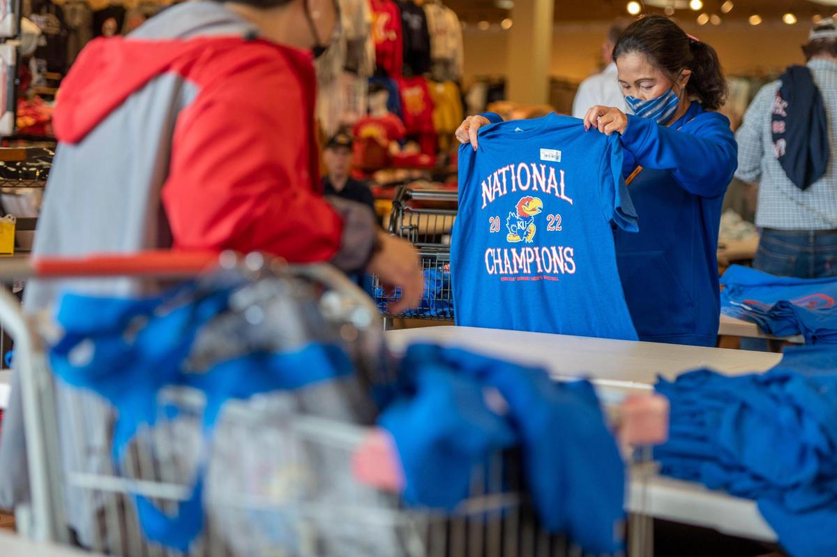 Kansas Jayhawks fan, Beth Merrick, looks for KU basketball championship gear at Rally House in Lenexa on Tuesday, April 5, 2022. Merrick said that she wanted to purchase KU apparel for her friends.