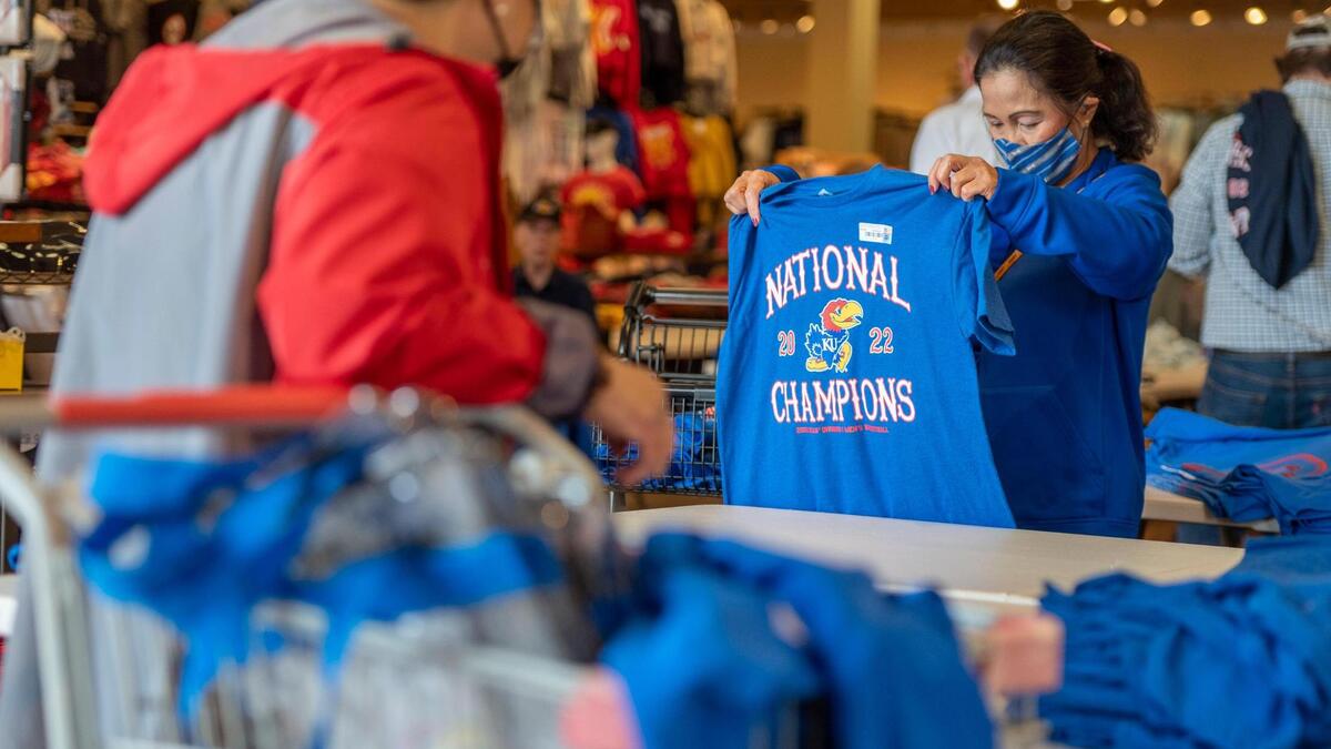 Kansas Jayhawks fan, Beth Merrick, looks for KU basketball championship gear at Rally House in Lenexa on Tuesday, April 5, 2022. Merrick said that she wanted to purchase KU apparel for her friends.