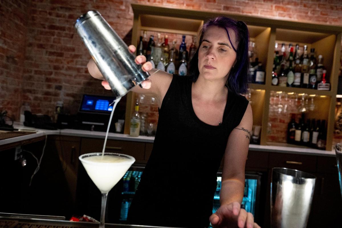 Singing bartender Vonne Whitman mixes cocktails and music on a Friday night at the Uptown Lounge.