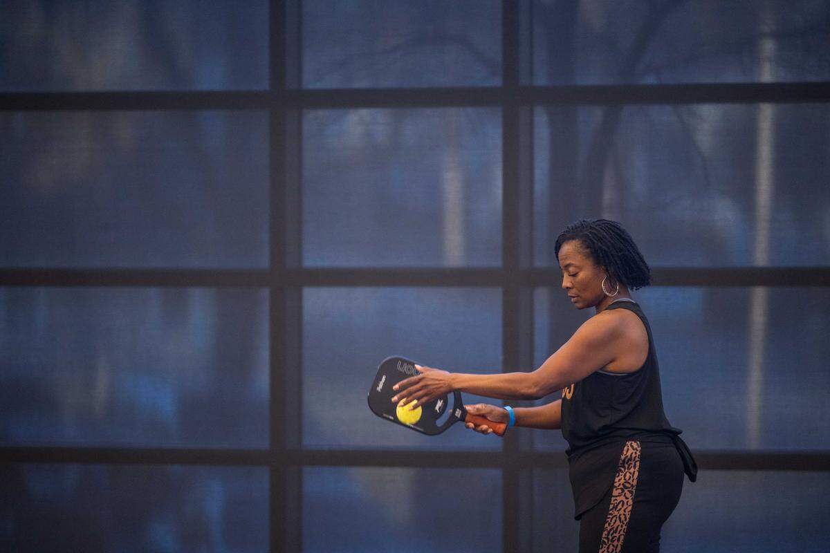 A woman prepares to serve during a meeting of the Black Pickleball Club at SW19 at the Stadium, on Sunday, Feb. 22, in Kansas City. 