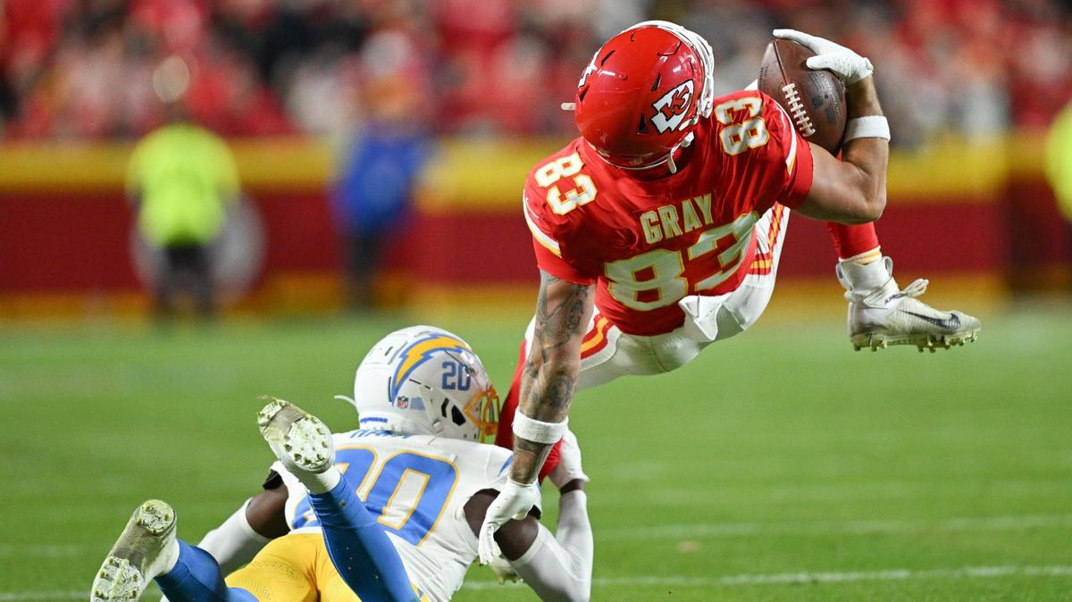 Kansas City Chiefs tight end Noah Gray (83) is tackled by Los Angeles Chargers cornerback Cam Hart (20) in the second quarter on Sunday, Dec. 8, 2024, at GEHA Field at Arrowhead Stadium.