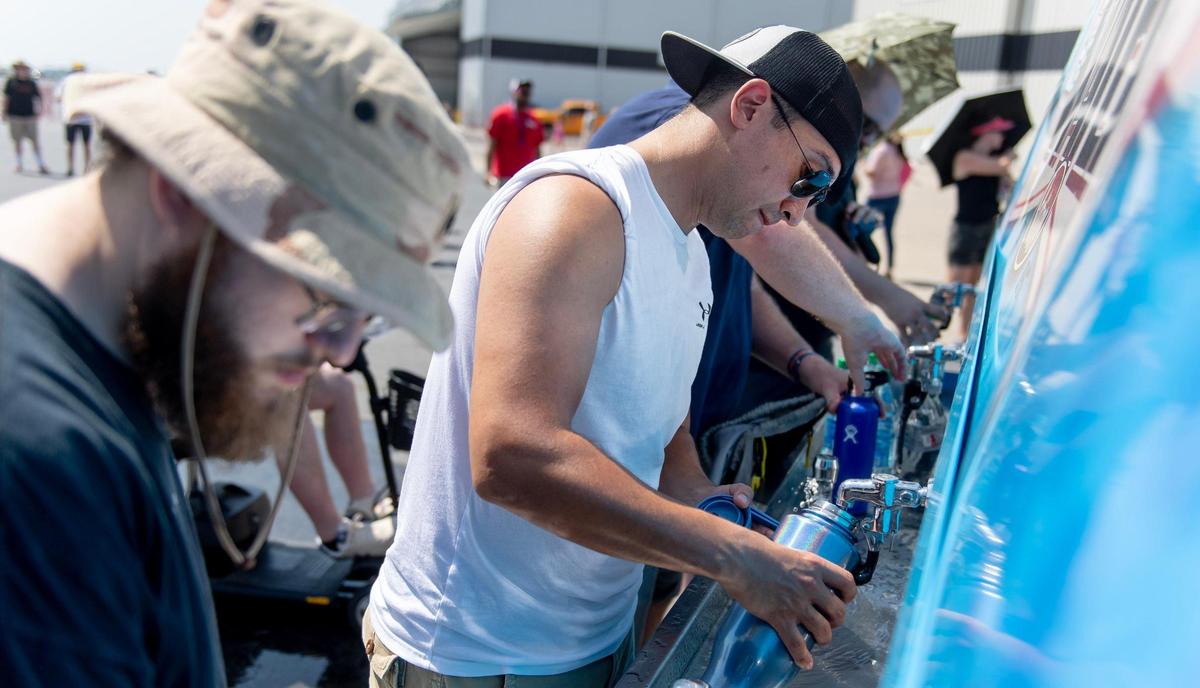 People fill up their water bottles during the Garmin KC Air Show on Saturday, Aug. 19, 2023, in New Century.