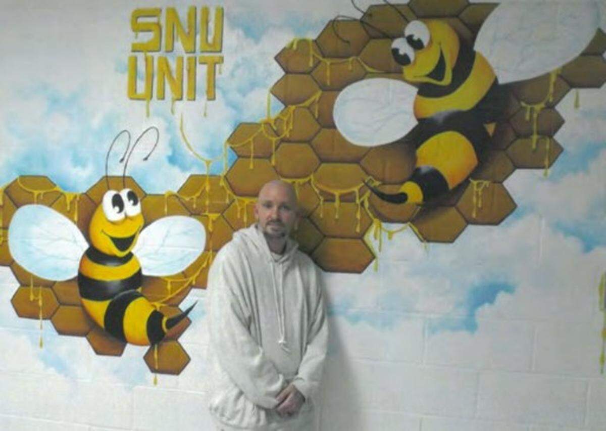 Michael Tisius stands near a mural he created for the Special Needs Unit at a Missouri prison. He was executed Tuesday, June 6, 2023.