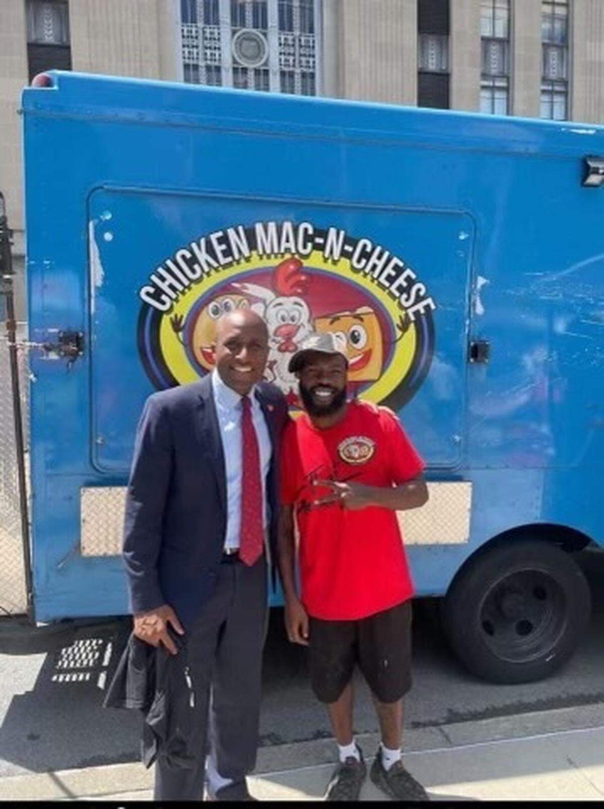 Kansas City mayor Quinton Lucas, left, visits Dyamund Shields Jr. at his food truck, Chicken-Mac-N-Cheese. Shields was serving food from the truck at a gathering near Prospect Avenue when he was fatally shot.
