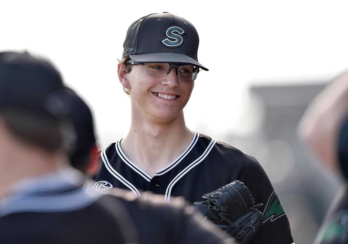 Staley High School pitcher Carter Rustad huddles with teammates before taking the mound in a home game against Liberty High School Friday, Apr. 5, 2019.