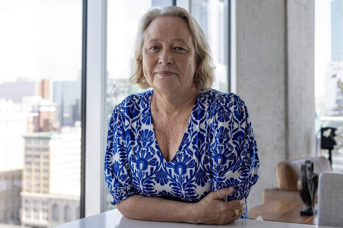 Pam Klein rests her arms on a counter for a portrait in the main dining area of her apartment at Two Light Luxury Apartments on Tuesday, June 30, 2026, in Kansas City.