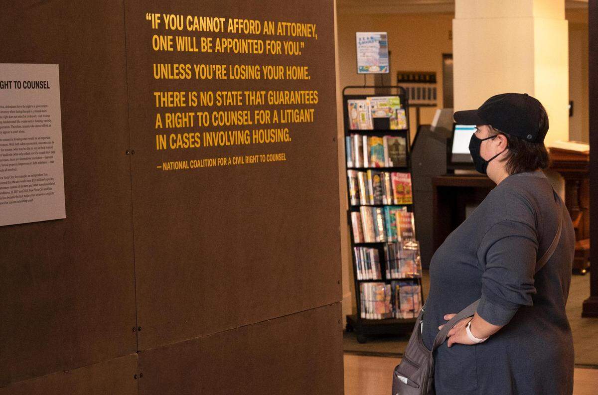 Bianca Barlaan explores the “Evicted” art exhibit at the Central Library downtown.