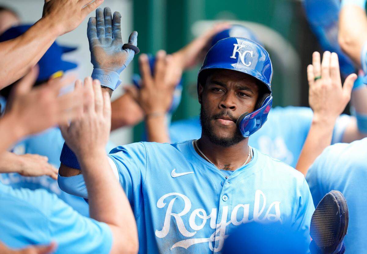 Kansas City Royals third baseman Maikel Garcia (11) is congratulated by teammates after scoring a run during the fourth inning against the New York Yankees at Kauffman Stadium on June 13, 2024.