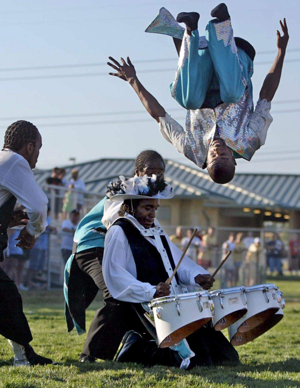 The Kansas City Marching Cobras did some impressive tricks while performing during opening ceremonies for the American Fastpitch Association 16-and-Under National Tournament in 2005.