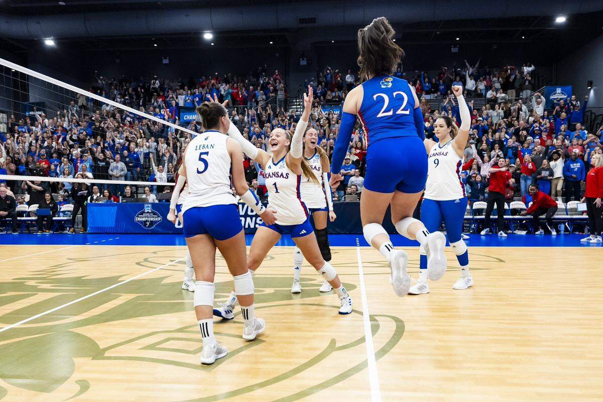 Kansas Jayhawks volleyball players celebrate their victory over Miami in the NCAA tournament in Lawrence, Kansas, on Friday, Dec. 5, 2025.
