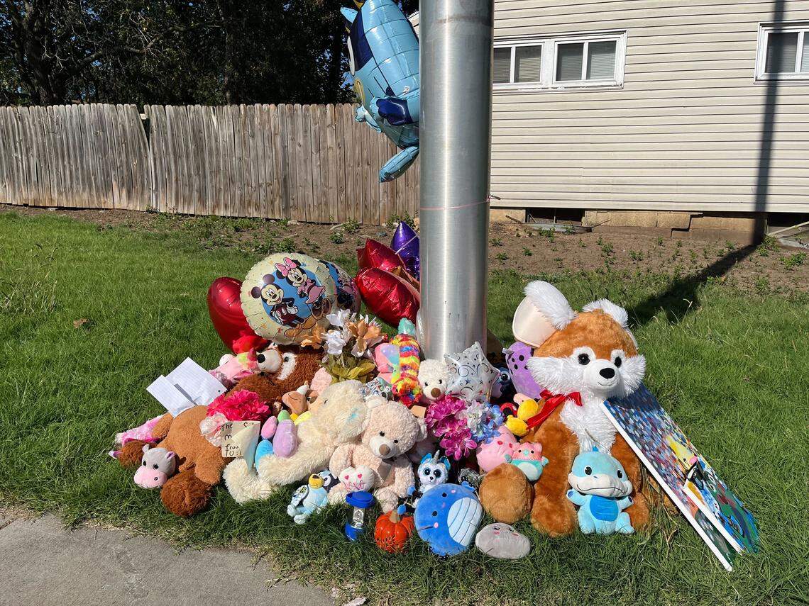 Flowers, notes, toys and balloons placed at a light post at the intersection where 3rd-grader Hazen Workman-Duffy was killed while biking to school Tuesday.