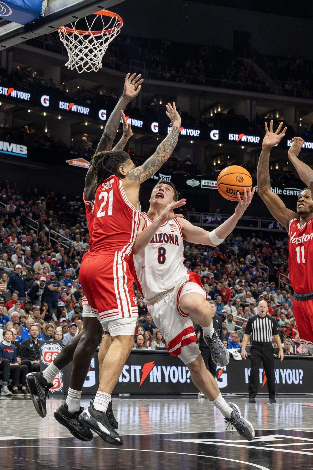 Arizona Wildcats forward Ivan Kharchenkov (8) makes a layup over Houston Cougars guard Emanuel Sharp (21) during the second half of the Big 12 Men's Basketball Tournament Championship game at T-Mobile Center on Saturday, March 14, 2026, in Kansas City.