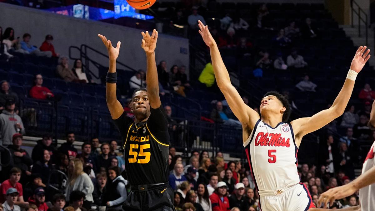 Missouri guard Sean East II shoots from three-point range while defended by Mississippi guard James White during the first half in Oxford, Miss., Tuesday, Jan. 24, 2023.
