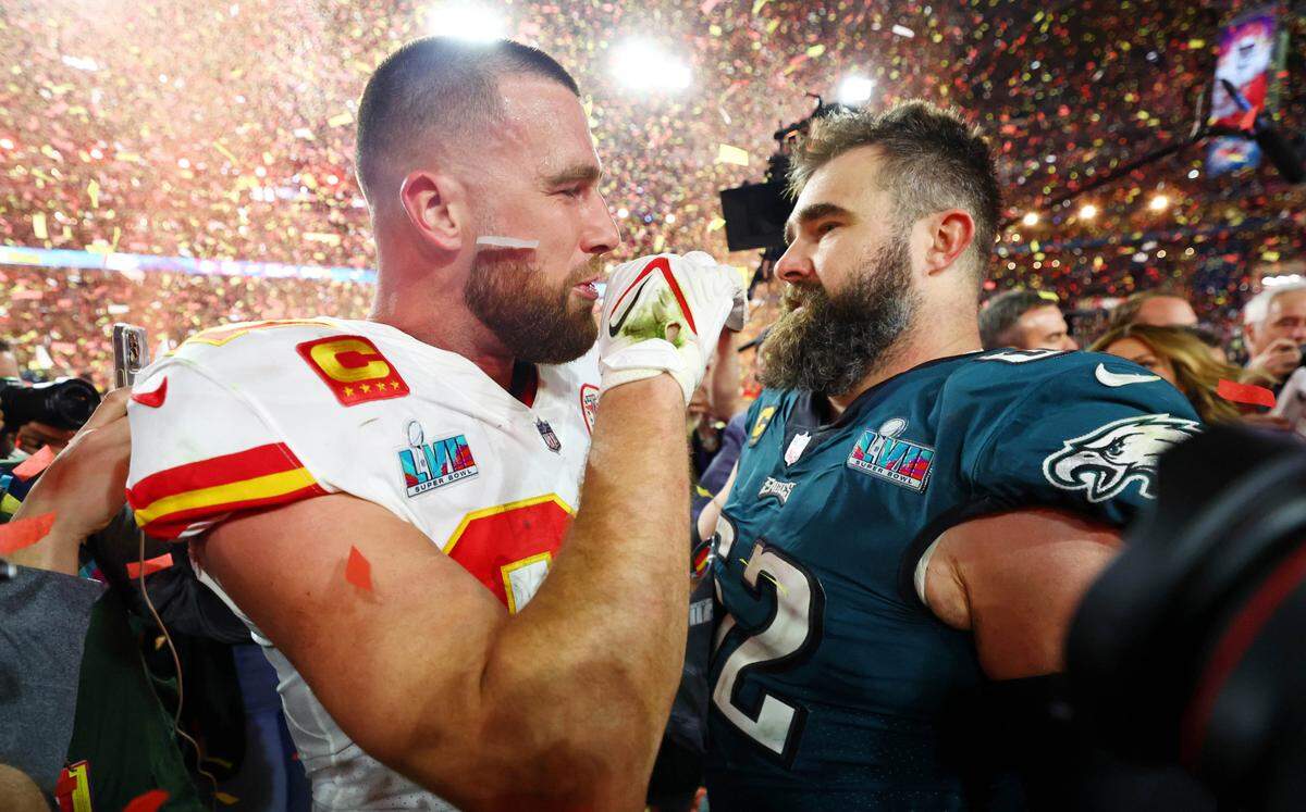 Kansas City Chiefs tight end Travis Kelce (87) talks with his brother and Philadelphia Eagles center Jason Kelce (62) after Travis’ Chiefs won Super Bowl LVII at State Farm Stadium.